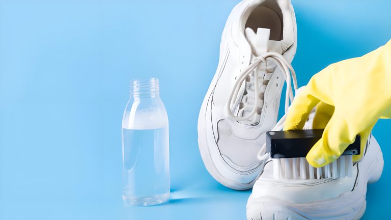 Cleaning white sneakers with a brush.