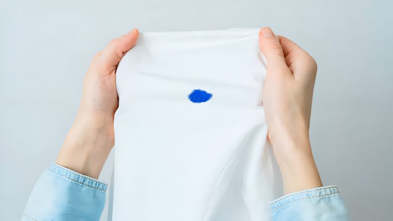 Unrecognizable woman holding a spoiled white shirt in her hands. Daily life stain concept