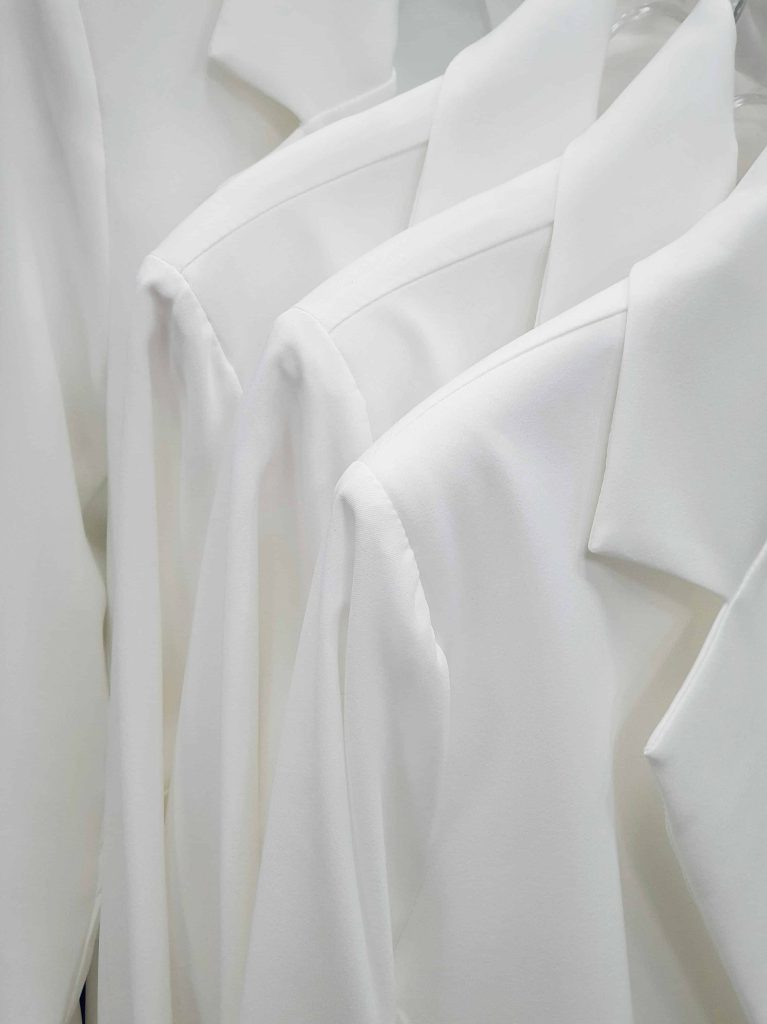 Close-up of Elegant White Clothing Hanging on a Rack
